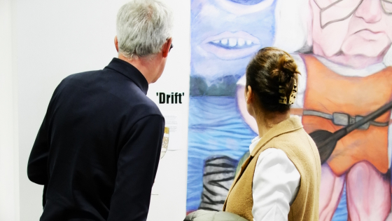 Man en vrouw kijken naar een schilderij